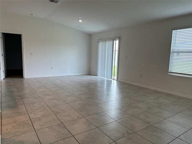 1950 Birnham Wood Bnd, Kissimmee, FL 34746 - empty room with plenty of natural light, light tile patterned floors, and vaulted ceiling