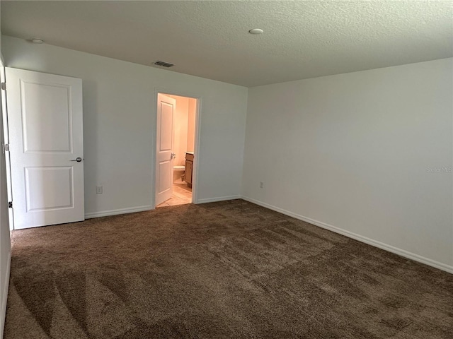 1950 Birnham Wood Bnd, Kissimmee, FL 34746 - unfurnished bedroom with carpet, a textured ceiling, and ensuite bathroom