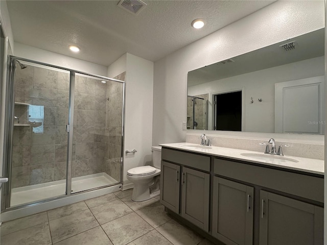 1950 Birnham Wood Bnd, Kissimmee, FL 34746 - full bathroom with double vanity, a shower stall, tile patterned flooring, and a textured ceiling