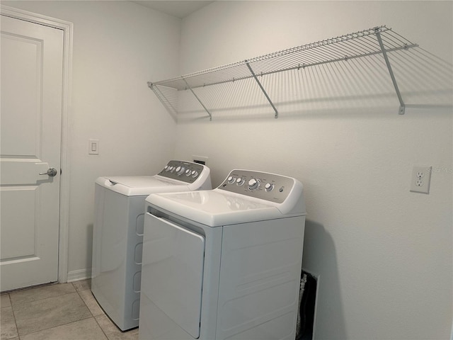 1950 Birnham Wood Bnd, Kissimmee, FL 34746 - laundry room featuring washer and dryer and light tile patterned flooring