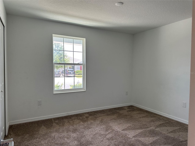 1950 Birnham Wood Bnd, Kissimmee, FL 34746 - carpeted spare room featuring a textured ceiling and baseboards