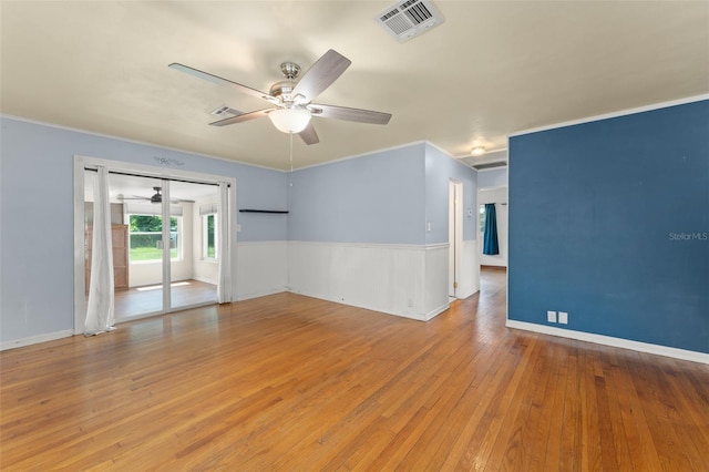 2538 Meadowview Ln, Deland, FL 32720 - spare room featuring a ceiling fan, hardwood / wood-style floors, ornamental molding, and a wainscoted wall