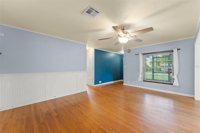 2538 Meadowview Ln, Deland, FL 32720 - spare room with ceiling fan, wood finished floors, wainscoting, and crown molding