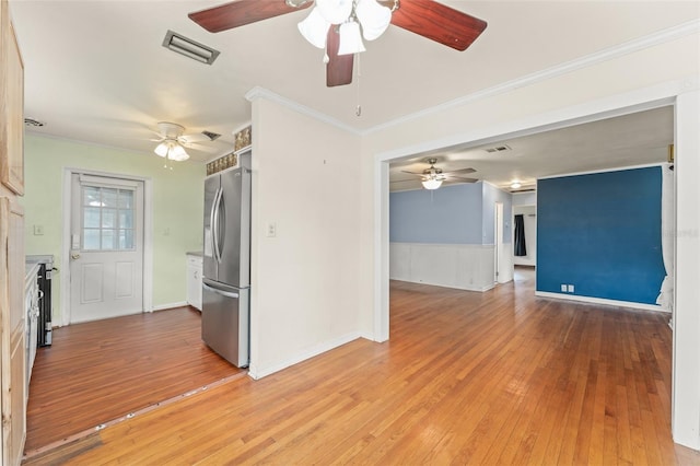 2538 Meadowview Ln, Deland, FL 32720 - empty room featuring light wood-style floors, ceiling fan, a wainscoted wall, and crown molding