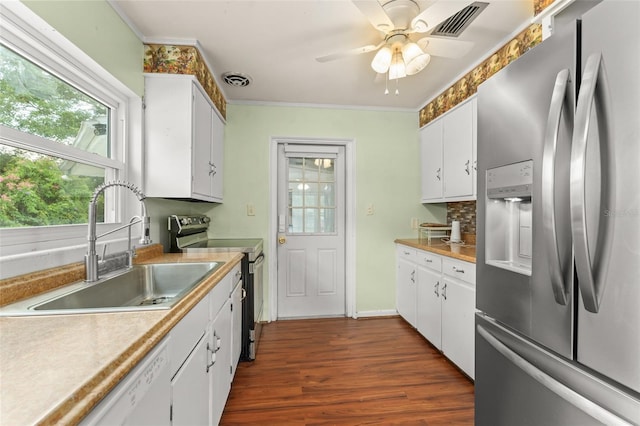 2538 Meadowview Ln, Deland, FL 32720 - kitchen with stainless steel appliances, ornamental molding, dark wood finished floors, white cabinets, and ceiling fan