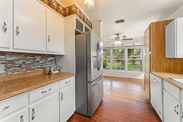 2538 Meadowview Ln, Deland, FL 32720 - kitchen with stainless steel fridge, dishwasher, backsplash, ceiling fan, and dark wood-style flooring