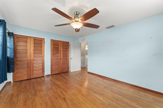 2538 Meadowview Ln, Deland, FL 32720 - unfurnished bedroom with two closets, light wood finished floors, and a ceiling fan