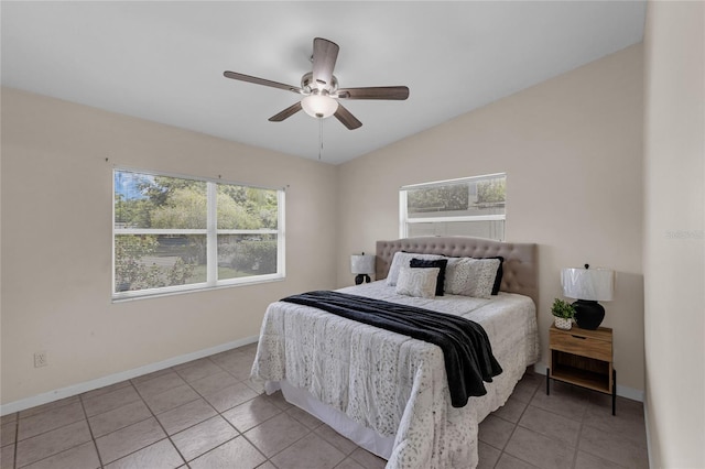 3430 Arbutus Ln, Winter Park, FL 32792 - bedroom with multiple windows, light tile patterned floors, vaulted ceiling, and a ceiling fan