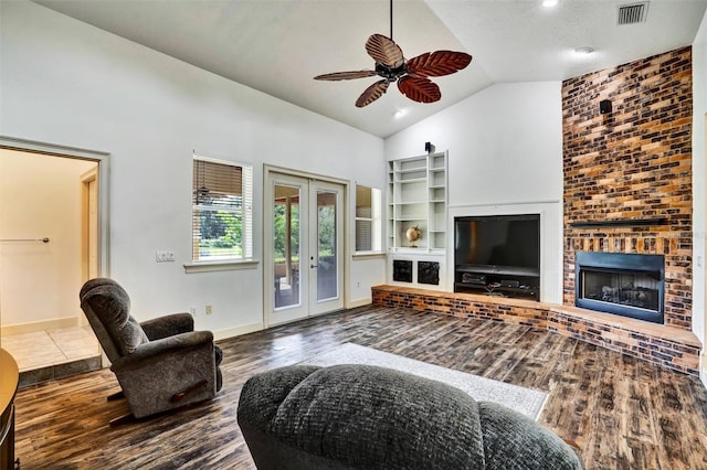 205 Trail Bridge Ct, Winter Garden, FL 34787 - living area featuring french doors, ceiling fan, wood finished floors, high vaulted ceiling, and a fireplace