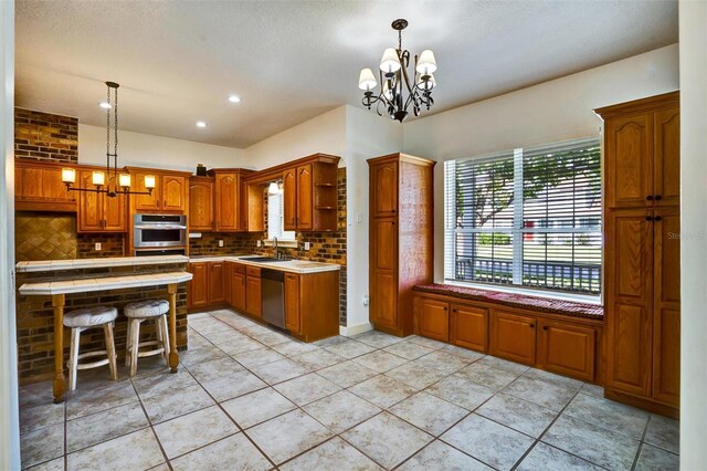 205 Trail Bridge Ct, Winter Garden, FL 34787 - kitchen with a chandelier, open shelves, appliances with stainless steel finishes, tasteful backsplash, and recessed lighting