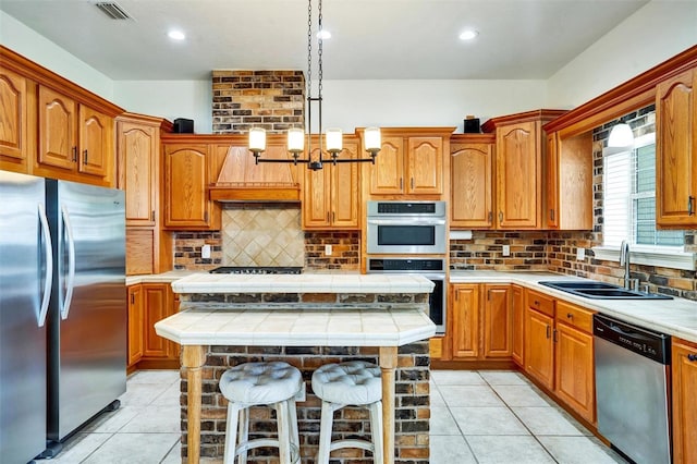 205 Trail Bridge Ct, Winter Garden, FL 34787 - kitchen featuring appliances with stainless steel finishes, light tile patterned flooring, tile counters, premium range hood, and recessed lighting