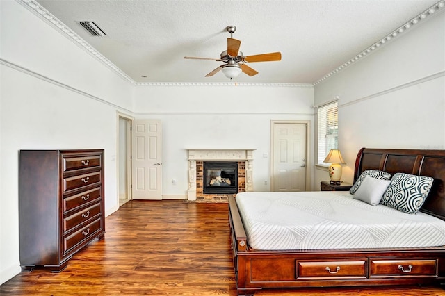 205 Trail Bridge Ct, Winter Garden, FL 34787 - bedroom with wood finished floors, a brick fireplace, a closet, crown molding, and a ceiling fan
