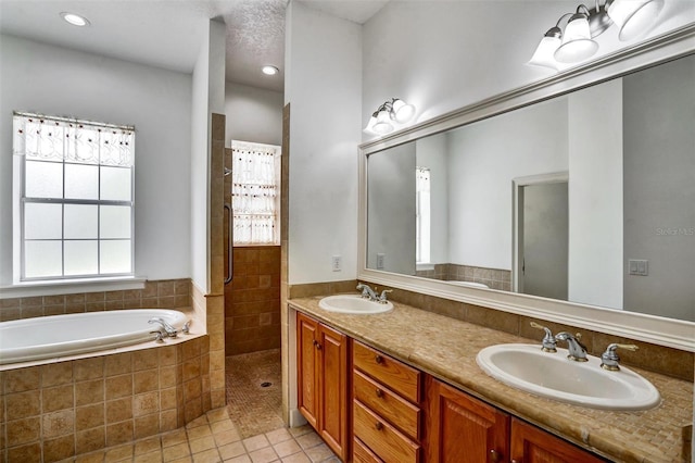 205 Trail Bridge Ct, Winter Garden, FL 34787 - full bath with tile patterned floors, a garden tub, double vanity, a tile shower, and recessed lighting