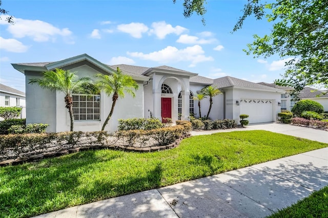 3711 Half Moon Dr, Orlando, FL 32812 - mediterranean / spanish house with a front yard, stucco siding, a garage, driveway, and a shingled roof