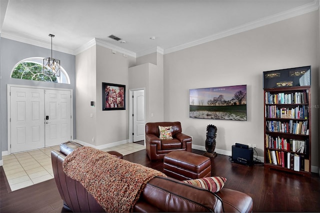 3711 Half Moon Dr, Orlando, FL 32812 - living area with wood finished floors, ornamental molding, a chandelier, and a towering ceiling