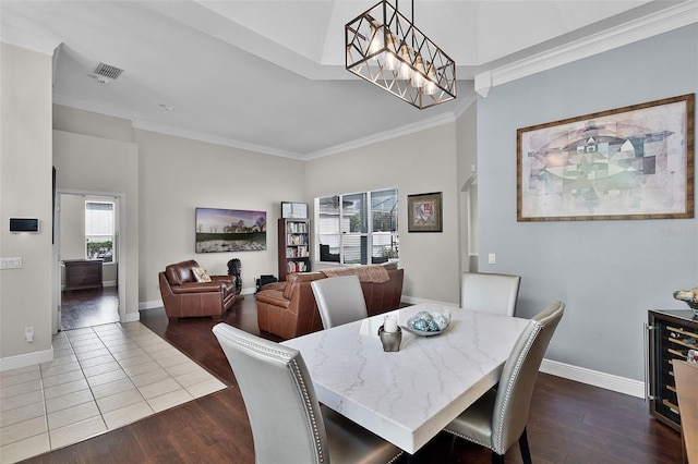 3711 Half Moon Dr, Orlando, FL 32812 - dining room with crown molding, dark wood-type flooring, arched walkways, and wine cooler