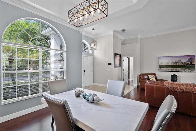 3711 Half Moon Dr, Orlando, FL 32812 - dining room featuring a chandelier, healthy amount of natural light, wood finished floors, and ornamental molding