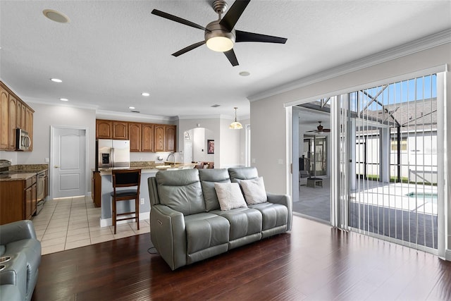 3711 Half Moon Dr, Orlando, FL 32812 - living area with ceiling fan, arched walkways, ornamental molding, light wood-type flooring, and recessed lighting