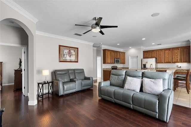 3711 Half Moon Dr, Orlando, FL 32812 - living area featuring a ceiling fan, arched walkways, recessed lighting, dark wood finished floors, and ornamental molding
