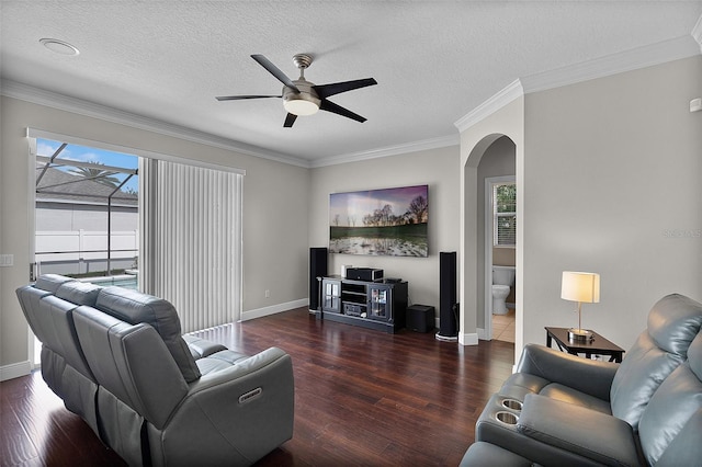 3711 Half Moon Dr, Orlando, FL 32812 - living room with arched walkways, wood finished floors, plenty of natural light, a ceiling fan, and crown molding