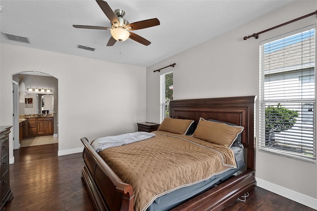 3711 Half Moon Dr, Orlando, FL 32812 - bedroom featuring dark wood finished floors, arched walkways, ensuite bathroom, and a ceiling fan