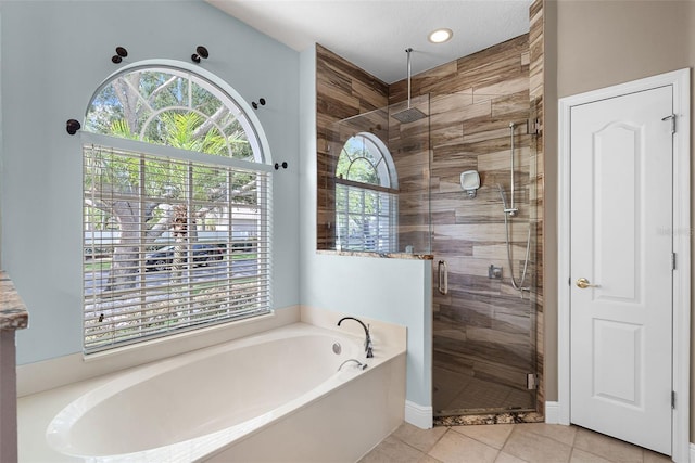 3711 Half Moon Dr, Orlando, FL 32812 - bathroom featuring a garden tub, a shower stall, healthy amount of natural light, tile patterned flooring, and recessed lighting