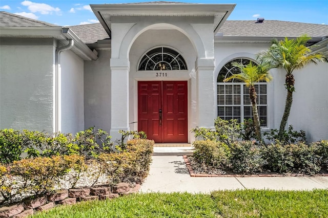 3711 Half Moon Dr, Orlando, FL 32812 - view of exterior entry featuring roof with shingles and stucco siding