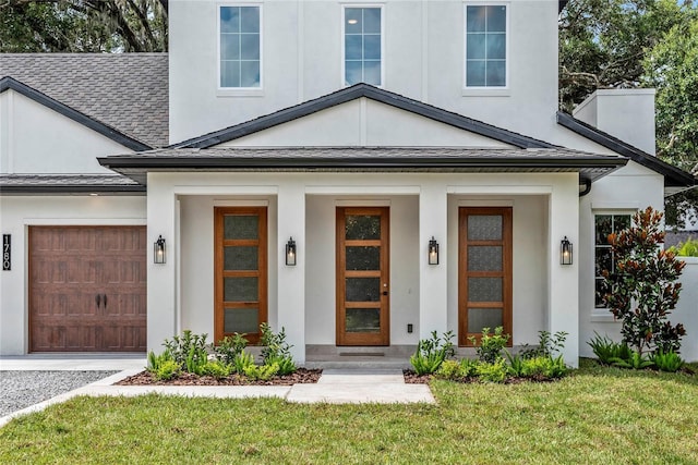 1780 Mizell Ave, Winter Park, FL 32789 - doorway to property with stucco siding, roof with shingles, a lawn, and a standing seam roof