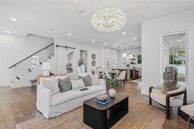1780 Mizell Ave, Winter Park, FL 32789 - living room with a barn door, wood finished floors, recessed lighting, stairway, and a chandelier