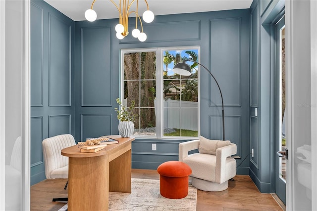 1780 Mizell Ave, Winter Park, FL 32789 - living area with a decorative wall, a chandelier, wood finished floors, and plenty of natural light