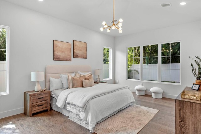 1780 Mizell Ave, Winter Park, FL 32789 - bedroom with multiple windows, a chandelier, light wood-style floors, and recessed lighting