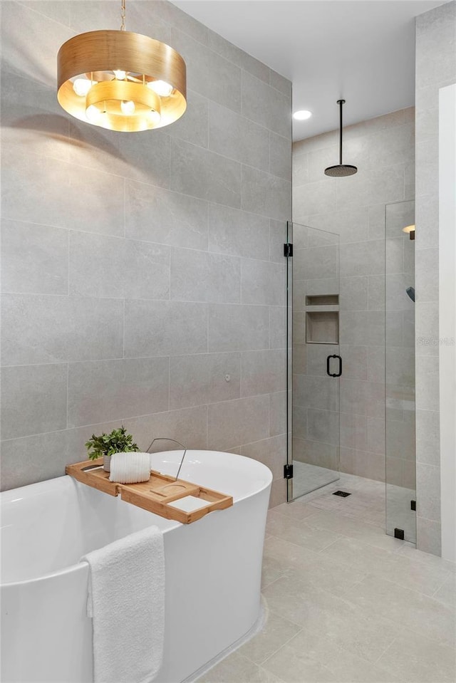 1780 Mizell Ave, Winter Park, FL 32789 - full bath featuring a shower stall, a freestanding tub, tile walls, and tile patterned floors