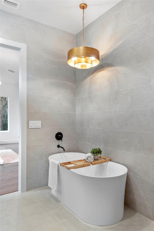 1780 Mizell Ave, Winter Park, FL 32789 - full bathroom with tile walls, a freestanding tub, and tile patterned floors