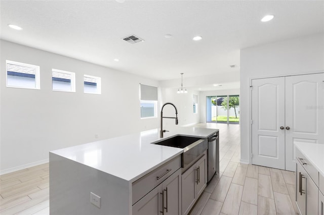12216 Encore At Ovation Way, Winter Garden, FL 34787 - kitchen featuring healthy amount of natural light, light countertops, recessed lighting, stainless steel dishwasher, and light wood-type flooring