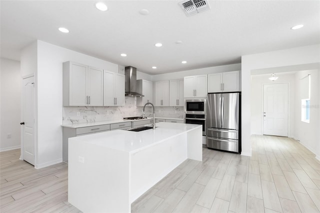 12216 Encore At Ovation Way, Winter Garden, FL 34787 - kitchen with stainless steel appliances, wall chimney range hood, tasteful backsplash, light countertops, and recessed lighting