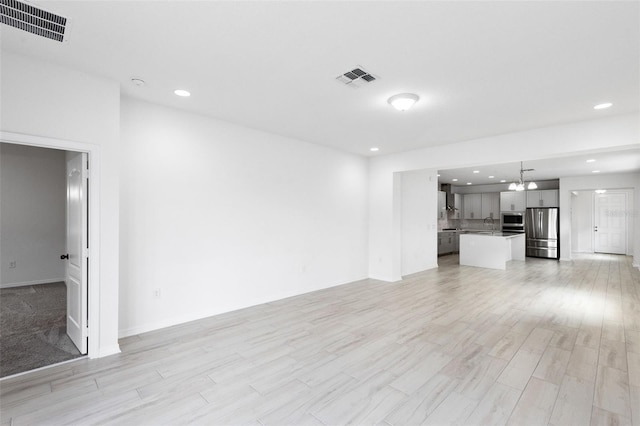 12216 Encore At Ovation Way, Winter Garden, FL 34787 - unfurnished living room with light wood-type flooring, a chandelier, and recessed lighting