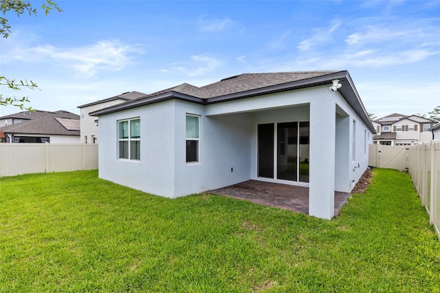 12216 Encore At Ovation Way, Winter Garden, FL 34787 - rear view of property with stucco siding, a fenced backyard, a patio area, and a shingled roof