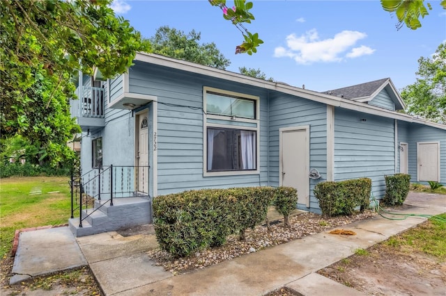 2728 Tally Ho Ave 2722, 2724, 2726, Orlando, FL 32826 - view of front of property with a balcony and a front yard