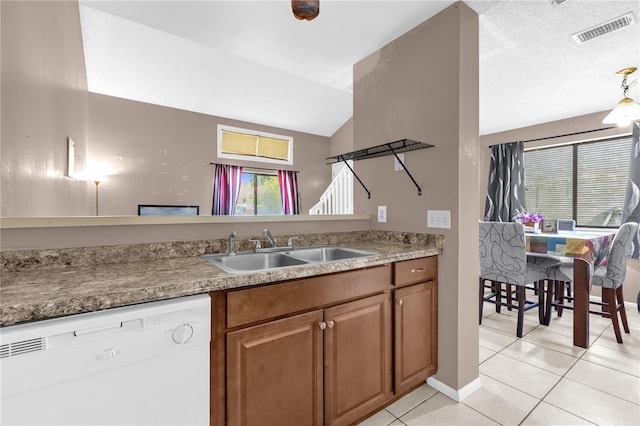 2728 Tally Ho Ave 2722, 2724, 2726, Orlando, FL 32826 - kitchen with dishwasher, light tile patterned floors, brown cabinets, vaulted ceiling, and hanging light fixtures