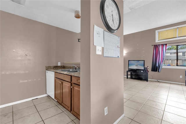 2728 Tally Ho Ave 2722, 2724, 2726, Orlando, FL 32826 - kitchen with light tile patterned floors, white dishwasher, brown cabinetry, and stone countertops