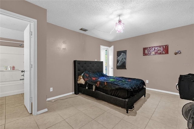 2728 Tally Ho Ave 2722, 2724, 2726, Orlando, FL 32826 - bedroom featuring a textured ceiling, light tile patterned floors, and ensuite bathroom