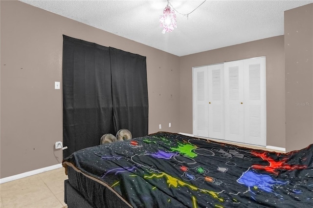 2728 Tally Ho Ave 2722, 2724, 2726, Orlando, FL 32826 - bedroom with tile patterned flooring, a textured ceiling, and a closet