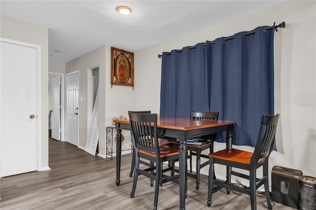 2728 Tally Ho Ave 2722, 2724, 2726, Orlando, FL 32826 - dining room featuring wood finished floors and a textured ceiling