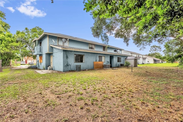 2728 Tally Ho Ave 2722, 2724, 2726, Orlando, FL 32826 - back of property with a yard and stucco siding