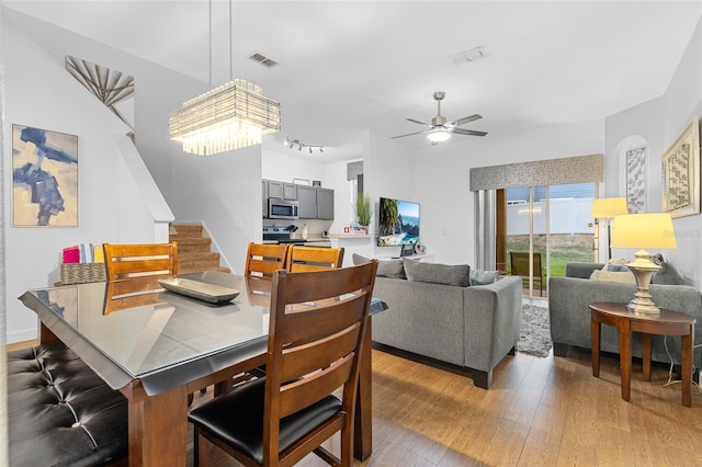 814 Calabria Ave, Davenport, FL 33897 - dining space featuring stairs, light wood-style flooring, and ceiling fan
