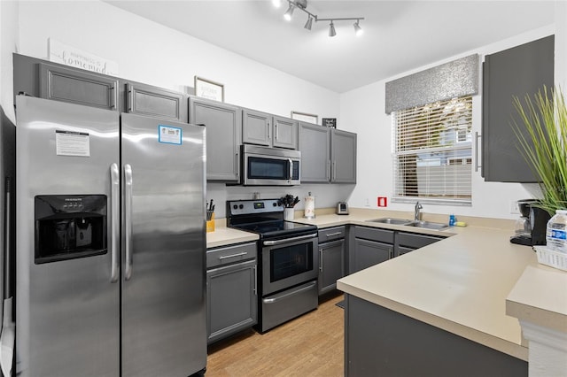 814 Calabria Ave, Davenport, FL 33897 - kitchen with stainless steel appliances, light countertops, light wood finished floors, and gray cabinets