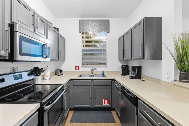 814 Calabria Ave, Davenport, FL 33897 - kitchen featuring appliances with stainless steel finishes, light countertops, and gray cabinets