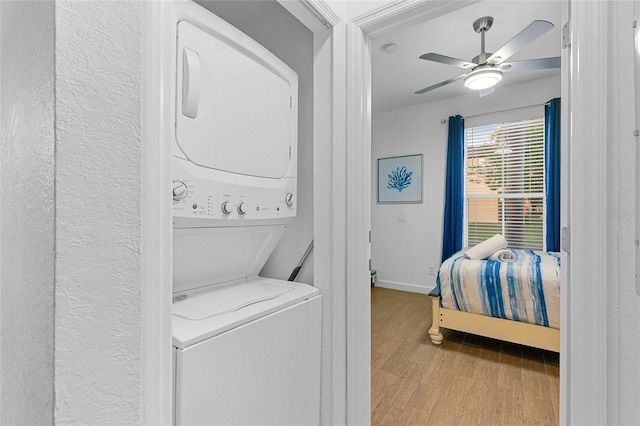 814 Calabria Ave, Davenport, FL 33897 - laundry room with estacked washer and dryer, wood finished floors, a textured wall, and ceiling fan
