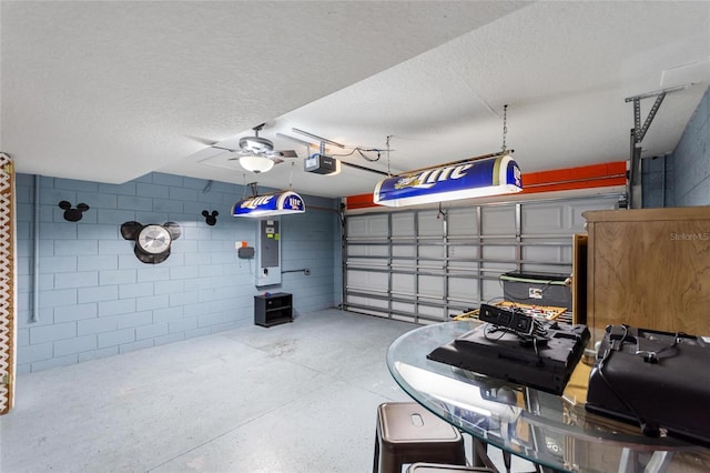 148 Miro Dr, Davenport, FL 33837 - garage featuring a garage door opener, electric panel, concrete block wall, and a ceiling fan