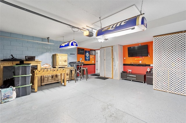 148 Miro Dr, Davenport, FL 33837 - garage featuring a workshop area, concrete block wall, and a garage door opener